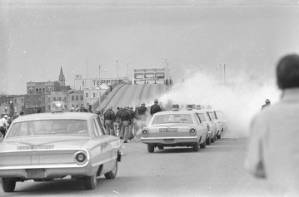 Alabama state police releasing tear gas on civil rights marchers crossing the Edmund Pettus Bridge in Selma, Alabama, on Bloody Sunday.