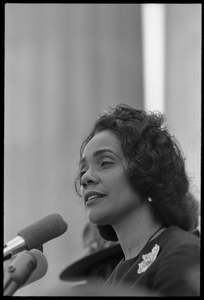 Coretta Scott King addressing the Solidarity Day crowd at the Poor People's March on Washington, speaking against the War in Vietnam Portrait in profile, at the microphones