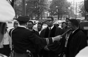 Police officer blocking ministers leading marchers during a civil rights demonstration in downtown Birmingham, Alabama.