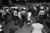 Police officers arresting young civil rights demonstrators during the Children's Crusade in Birmingham, Alabama.