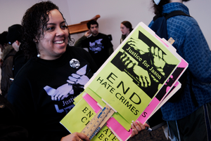 Justice for Jason rally at UMass Amherst: student protester with signs in support of Jason Vassell