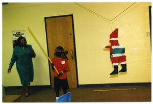 Boy with Beating Stick During Christmas Party