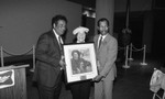 Ruth Washington and others posing with a painting at the California African American Museum, Los Angeles, 1985