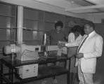 Students looking at equipment in a science classroom at Tuskegee Institute in Tuskegee, Alabama.