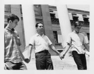 Mississippi State Sovereignty Commission photograph of Richard Barrett standing on the steps of the Mississippi State Capitol between two unidentified teenagers and holding their hands during a demonstration, Jackson, Mississippi, 1967 July 30