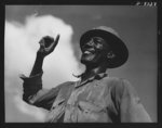 Tennessee Valley Authority. Construction of Douglas Dam.  Negro flagman directing dump carts at TVA's new Douglas Dam on the French Broad River. This dam will be 161 feet high and 1,682 feet long, with a 31,600 acre reservoir area extending forty-three miles upstream. With a useful storage capacity of approximately 1,330,000 acre-feet this reservoir will make possible the addition of nearly 100,000 kilowatts of continuous power to the TVA system in dry years and almost 170,000 kilowatts in the average year