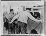 [Police officer seizing Dr. Martin Luther King by the seat of his trousers and leading him to a paddy wagon, after anti-segregation march in Birmingham, Ala.]