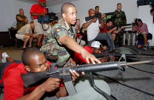 Tampa Bay Buccaneers, Super Bowl XXXVII Champions, get a taste of military life as they get some hands on training firing the 5.56 mm M16A2 rifle simulator at MacDill Air Force Base, Florida (FL)