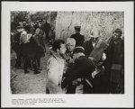 [Refugees 1: Men at border crossing being inspected by police]