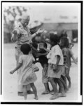 [Children appealing to Walter F. White for handouts, on a military base somewhere in the Pacific]