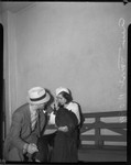 Ann Forst sits with an unidentified man at the county jail after being charged with operating a prostitution ring, Los Angeles, 1940