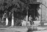 Man sitting on porch steps.