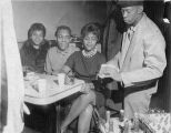 Customers being served by waiter at Rice's Tap Room and Oven