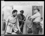 Members of the Black Panther Party are met on the State Capitol steps by state police Lt. Ernest Holloway, who informed them that they would be allowed to keep their weapons as long as they caused no trouble or did not try to disturb the peace