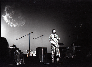 Taj Mahal in concert at Northfield, Mass.: Taj Mahal standing at microphone