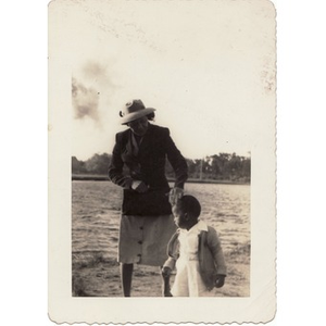 A woman strokes a small child's head