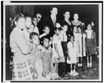 [Billie Holiday with a group of African American children in a school in Merriam, Kansas]