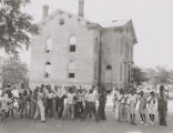 African American children outside a brick school building in Montgomery, Alabama.