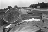 Trailer full of cotton being pulled by a tractor down a paved road near Mount Meigs in Montgomery County, Alabama.