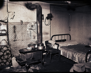 Interior with stove and bed : photonegative.