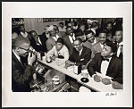 [Black Muslim leader Malcolm X photographing Cassius Clay surrounded by fans after he beat Sonny Liston for the heavy weight championship, Miami, February, 1964]