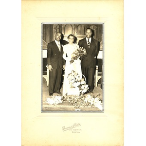 Laymon Hunter poses with a bride and groom