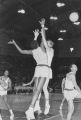 A Marquette basketball player is blocked by an opposing athlete, 1970