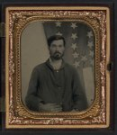 [Unidentified soldier in Union sack coat in front of American flag]