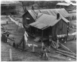 [House and yard with clothes hanging on the line in a rural area]