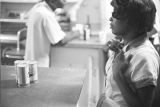 Waitress standing at the counter at Tom's Place at 648 South Holt Street in Montgomery, Alabama.