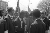 Fred Shuttlesworth, Ralph Abernathy and others talking in the street at Martin Luther King, Jr.'s funeral.