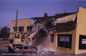 Bulldozer tearing down a storefront