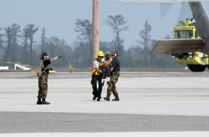 An evacuee is carried by military personnel from a helicopter at Louis Armstrong International Airport (MSY) in New Orleans, Louisiana (LA), in support of the Hurricane Katrina relief effort