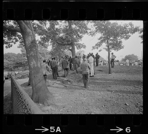 Group of reporters and cameramen standing by fence during Black student rally in Franklin Park