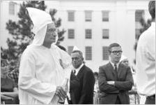 Klansman listening to a speaker at a Ku Klux Klan rally in Montgomery, Alabama.