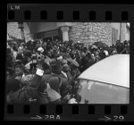 Crowd encircling casket and hearse at funeral of singer Sam Cooke in Los Angeles, Calif., 1964