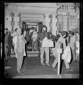 Black Boston University students carry provisions out of BU Administration Building as their 12-hour sit-in in the building ends