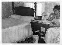 Woman Reading Next to Bed