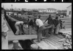 Negro stevedores loading stove on boat, Burwood, Louisiana