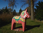 Dala horse in a yard in Scandia, Minnesota, a small community on the site of the state's first Swedish settlements (among what would be hundreds to which Scandinavians emigrated in the mid-1800s). Dala horses are quintessential Swedish decorative handicrafts that trace to the Swedish province of Darlana