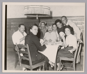 Photograph of a group of people playing cards