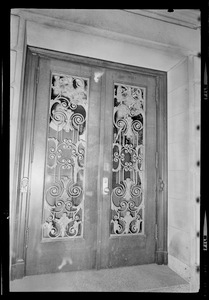 Close up of door with a demonstrator seen in the window of the Administration Building at Boston University