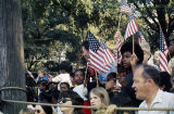 Thumbnail for Spectators waving American flags at the Veterans Day parade in Birmingham, Alabama.