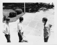 Mississippi State Sovereignty Commission photograph of Richard Barrett standing on the steps of the Mississippi State Capitol between two unidentified teenagers and looking down the walkway at a police officer and G. Garland Lyell, Jackson, Mississippi, 1967 July 30