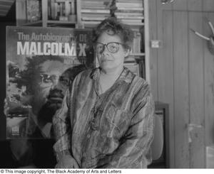 Laura Jean Lacy posing with illustrated cover of Malcolm X #2