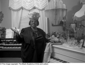 Photograph of gospel singer Francine Morrison posing with her awards #2