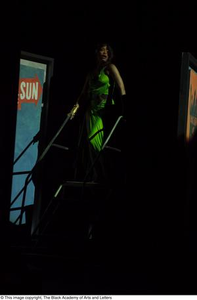 Performer in green dress on stairs