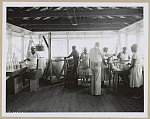 [African American women and men canning food in metal cans]