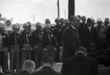 Minister, possibly George MacPherson Docherty, leading civil rights marchers in prayer on the south side of the Edmund Pettus Bridge in Selma, Alabama, on Turnaround Tuesday.