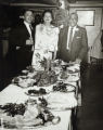 Smiths and their Grandson Roger Beasley stand at holiday table